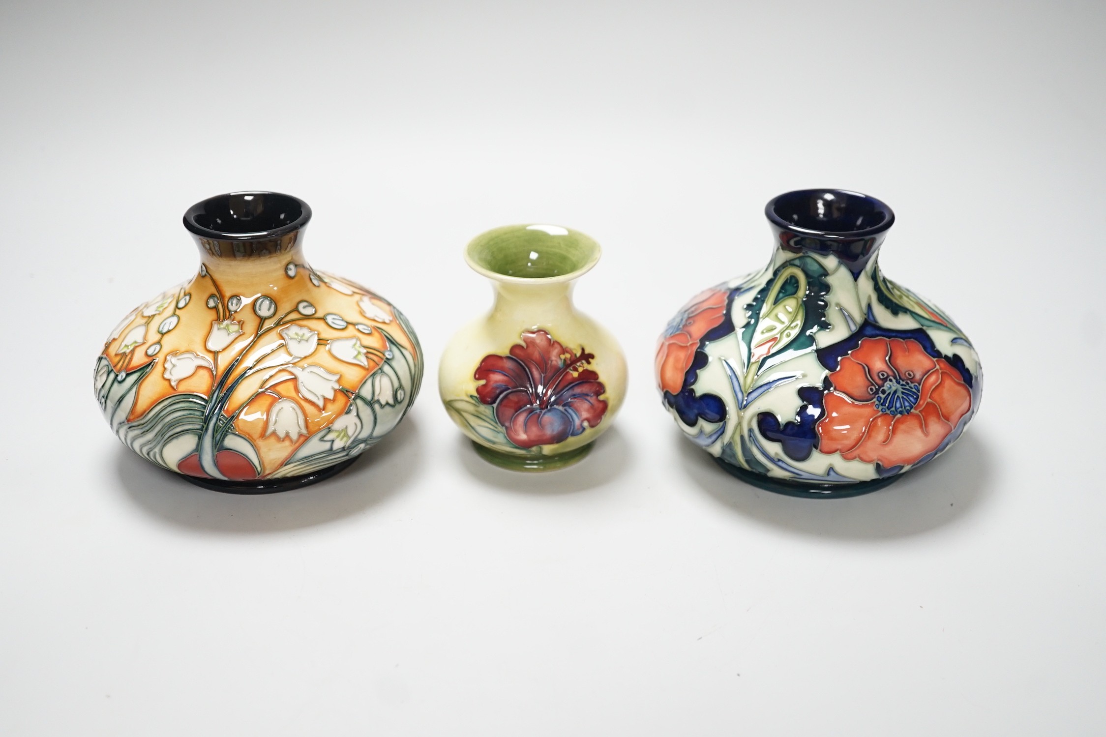 Three Moorcroft vases, in Poppy, Hibiscus and Tulip designs, tallest 10.5 cm, one boxed